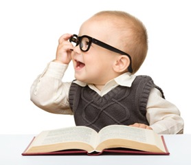 Little child play with book and glasses