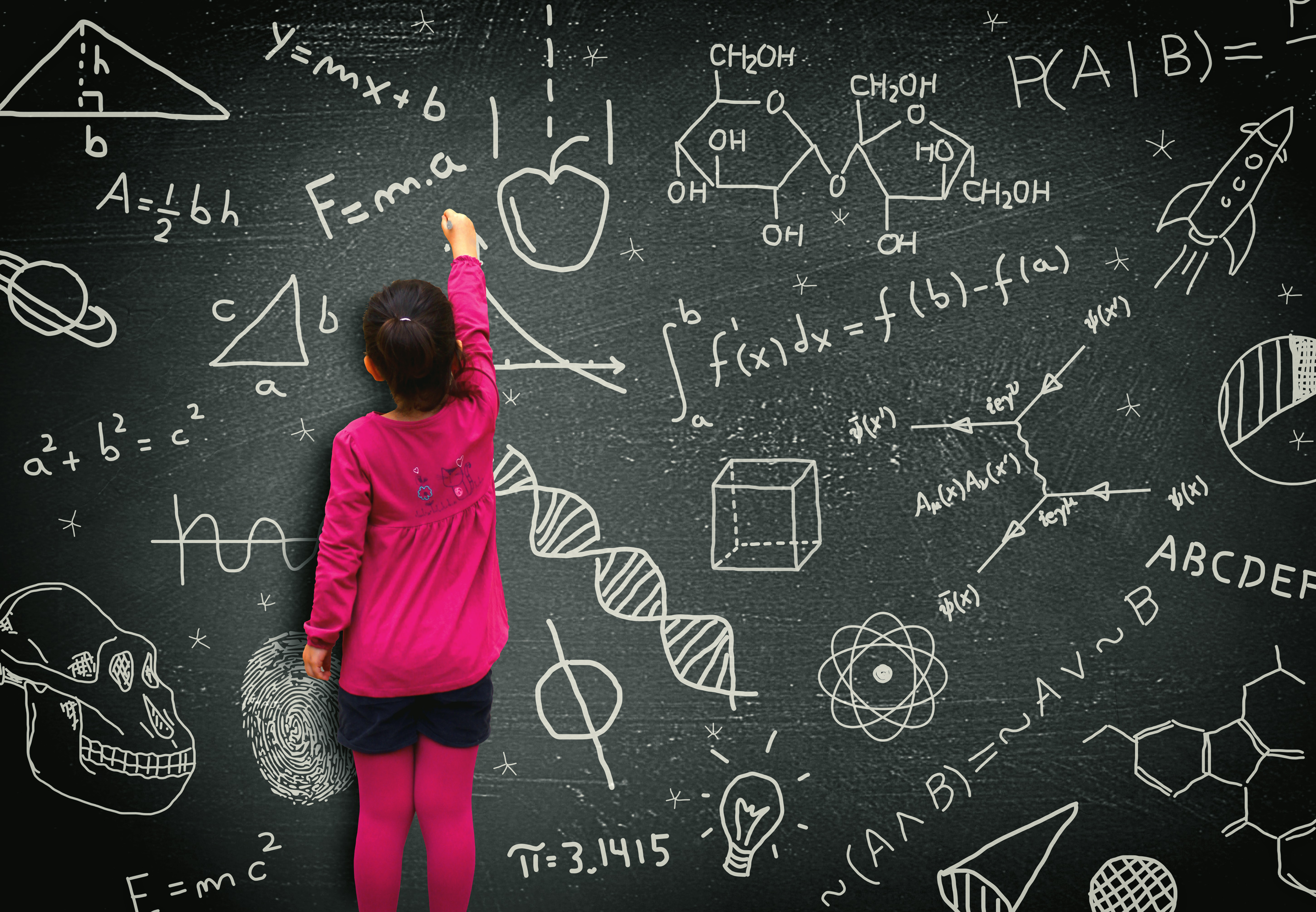 Little girl writing on blackboard - Learning and knowledge concept